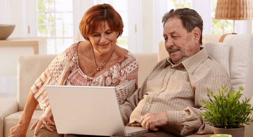 couple looking at computer on couch
